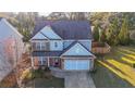 House with fenced backyard, two-car garage, and driveway at 214 Walnut Ridge Rd, Canton, GA 30115