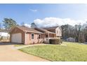 Side view of a two-story house with attached garage and manicured lawn at 2323 Cedar Valley Ct, Lawrenceville, GA 30043