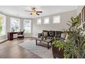 Inviting living room with a cozy seating area, wood floors, and plenty of natural light from multiple windows at 4259 Hansford Loop, Marietta, GA 30064