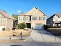 Two-story brick home with a large driveway and landscaping at 5150 Amberland Sq, Atlanta, GA 30349