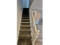 Carpeted staircase with white railing leading upstairs at 1608 Briarcliff Ne Rd # 3, Atlanta, GA 30306