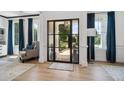 Bright entryway with a modern glass door and hardwood floors at 334 Spotted Ridge Cir, Woodstock, GA 30188