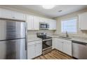 Modern kitchen featuring stainless steel appliances and white cabinets at 7618 Mcgillicuty Dr, Union City, GA 30291