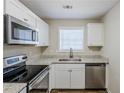 Modern kitchen with granite countertops and stainless steel appliances at 7618 Mcgillicuty Dr, Union City, GA 30291
