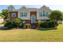 Two-story home with a brick facade and a grassy lawn at 4171 High Country Dr, Douglasville, GA 30135