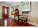 Entryway with hardwood floors, wooden desk, and framed artwork at 4480 Lost Mountain Dr, Powder Springs, GA 30127