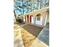 Welcoming brick front entrance with a red front door and an archway detail, inviting curb appeal at 869 Meadow Rock Way, Stone Mountain, GA 30083