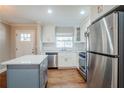 Updated kitchen with white cabinets, stainless steel appliances, and a large island at 2756 Plantation Dr, East Point, GA 30344