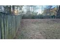 Large backyard with a wooden fence and grassy area at 2029 Downs, Lithonia, GA 30058