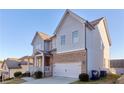 Two-story house with gray siding, brick accents, and a two-car garage at 1501 Still Ridge Ln, Lawrenceville, GA 30045