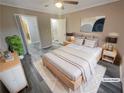 Virtually staged bedroom with wood floors and ceiling fan at 501 Country Park Se Dr, Smyrna, GA 30080