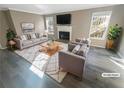 Virtually staged living room features fireplace and hardwood floors at 501 Country Park Se Dr, Smyrna, GA 30080