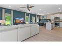 Open concept living area with sectional sofa and large windows at 10 Camellia Dr, Fairburn, GA 30213