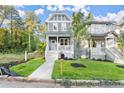 Two-story craftsman home with gray siding, white trim, and a landscaped front yard at 1697 Thomas St, Decatur, GA 30032