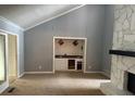 Living room with wet bar and stone fireplace at 8374 Carlton Rd, Riverdale, GA 30296