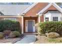 Inviting front entrance with gray door and manicured landscaping at 447 Two Iron Nw Trl, Kennesaw, GA 30144