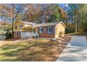 House exterior with a long driveway and mature trees surrounding the property at 5214 Parkside Dr, Conyers, GA 30094