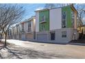 Contemporary townhome with a two-car garage and a vibrant green and white exterior at 1412 Peter Haughton Nw Way, Atlanta, GA 30318
