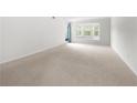 Bright bedroom with hardwood floors and sliding glass door to balcony at 6851 Roswell Rd # I29, Atlanta, GA 30328