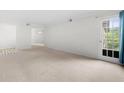 Open living area with neutral decor and access to balcony at 6851 Roswell Rd # I29, Atlanta, GA 30328