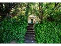 Stone steps leading to the house, framed by lush green foliage at 99 Moreland Se Ave, Atlanta, GA 30316