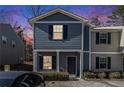 Attractive two-story townhome, gray siding, black shutters, inviting entryway at 2137 Chadwick Road, Atlanta, GA 30331