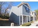 Gray-sided townhome with white columns, showcasing the side profile of the house at 2137 Chadwick Road, Atlanta, GA 30331