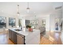 Open concept kitchen with island, stainless steel appliances, and hardwood floors at 1099 Hawthorne Ne St, Atlanta, GA 30307