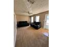 Living room featuring two black reclining sofas and carpeted floors at 1779 Big Horn Se Ct, Conyers, GA 30013