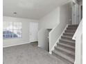 Spacious living room with grey carpet and staircase at 2089 Glenwood Downs Dr, Decatur, GA 30035