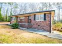 Brick house with a wooden porch and landscaping at 2580 County Line Sw Rd, Atlanta, GA 30331