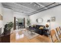 Open living area with hardwood floors, exposed beams, and ample natural light at 800 Peachtree St # 1112, Atlanta, GA 30308