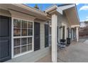 House exterior showcasing a covered entryway with columns and shutters at 4955 R H Smith Blvd Blvd, Sugar Hill, GA 30518