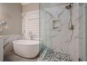 Elegant bathroom with a large soaking tub, walk-in shower, and marble tile at 6204 Woodlore Nw Dr, Acworth, GA 30101