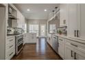 Spacious kitchen with white cabinets, stainless steel appliances, and hardwood floors at 6204 Woodlore Nw Dr, Acworth, GA 30101