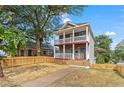 Charming two-story house with a landscaped yard and wooden fence at 1410 Metropolitan Sw Pkwy, Atlanta, GA 30310