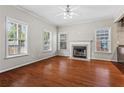 Living room with hardwood floors, fireplace, and multiple windows at 1410 Metropolitan Sw Pkwy, Atlanta, GA 30310