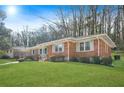 Side view of brick ranch home showcasing large yard at 719 Lynn Valley Sw Rd, Atlanta, GA 30311