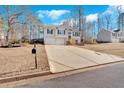 Two-story house with a long driveway, leading to a two-car garage and front entrance at 66 Trevor Way, Temple, GA 30179