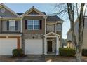 Front view of townhome, showcasing stone and siding at 962 Pierce Ivy Ct, Lawrenceville, GA 30043