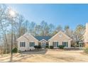 Tan house with green shutters, stone accents, and landscaping at 3639 Fowler Rdg, Douglasville, GA 30135