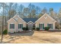 Charming single-story home with stucco exterior, green shutters, and landscaped front yard at 3639 Fowler Rdg, Douglasville, GA 30135
