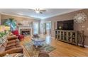 Inviting living room with a stone fireplace, hardwood floors, and comfortable seating at 3639 Fowler Rdg, Douglasville, GA 30135