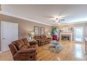 Cozy living room with stone fireplace, ceiling fan, hardwood floors, and comfortable seating at 3639 Fowler Rdg, Douglasville, GA 30135