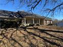 Brick ranch home with covered porch and landscaping at 144 Rockbridge Sw Rd, Lilburn, GA 30047