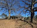 Ranch house nestled amongst mature trees at 144 Rockbridge Sw Rd, Lilburn, GA 30047