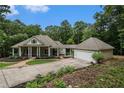 House exterior, large green home with attached garage and landscaped lawn at 318 Liberty Ln, Canton, GA 30114