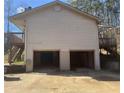 Two-car garage with concrete driveway and access to back deck at 5234 Maroney Mill Rd, Douglasville, GA 30134