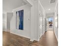 Bright and airy foyer with hardwood floors and modern art at 3161 Greyton Dr, Buford, GA 30519