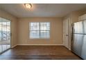 Bright dining area with wood-look flooring and sliding glass door at 444 Kara Ln, Mcdonough, GA 30253